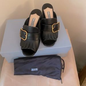 Prada Black Leather Block Heel Mules with Brass Buckle and Fringe